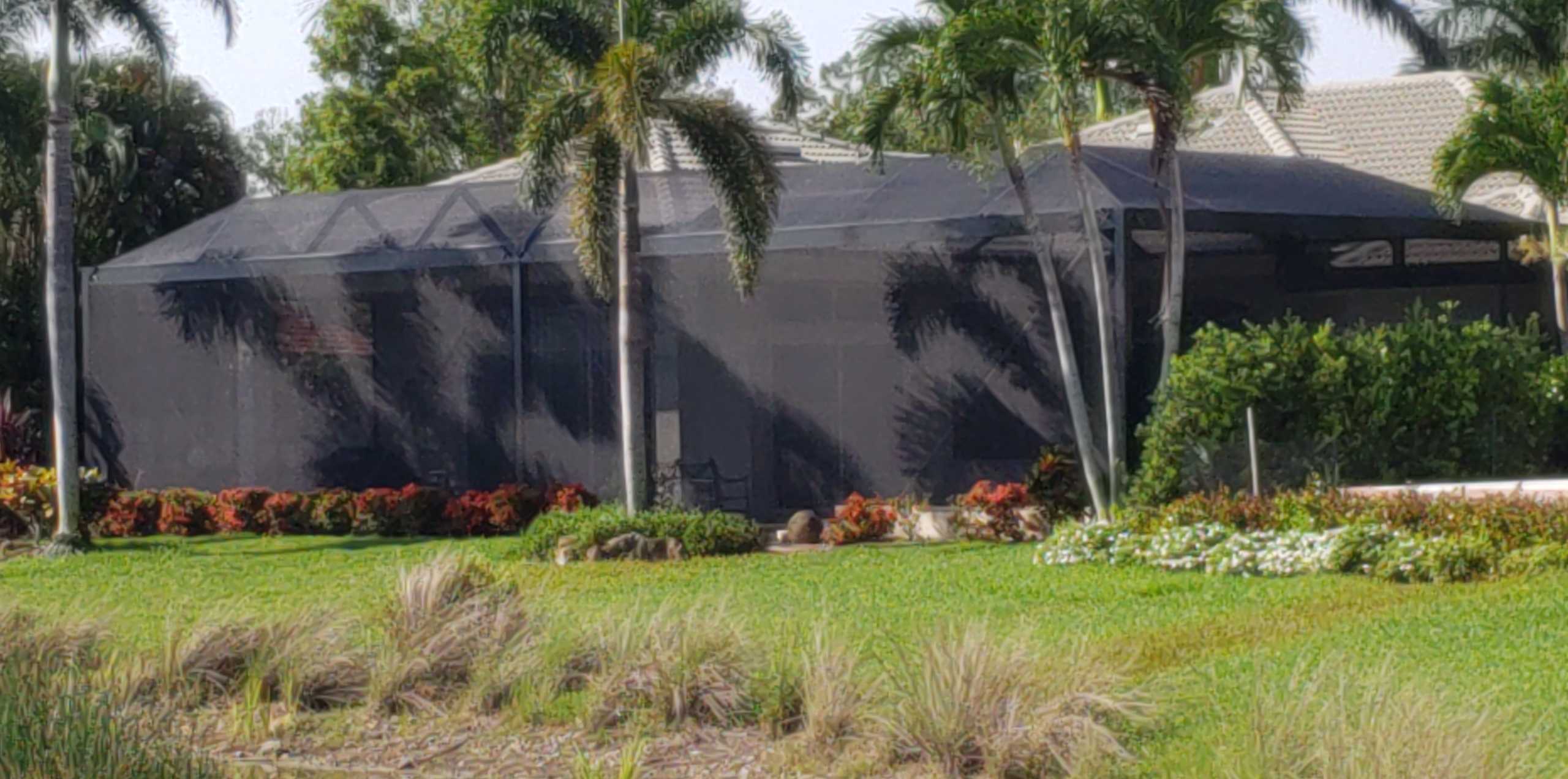 A beautifully lit pool enclosure at sunset